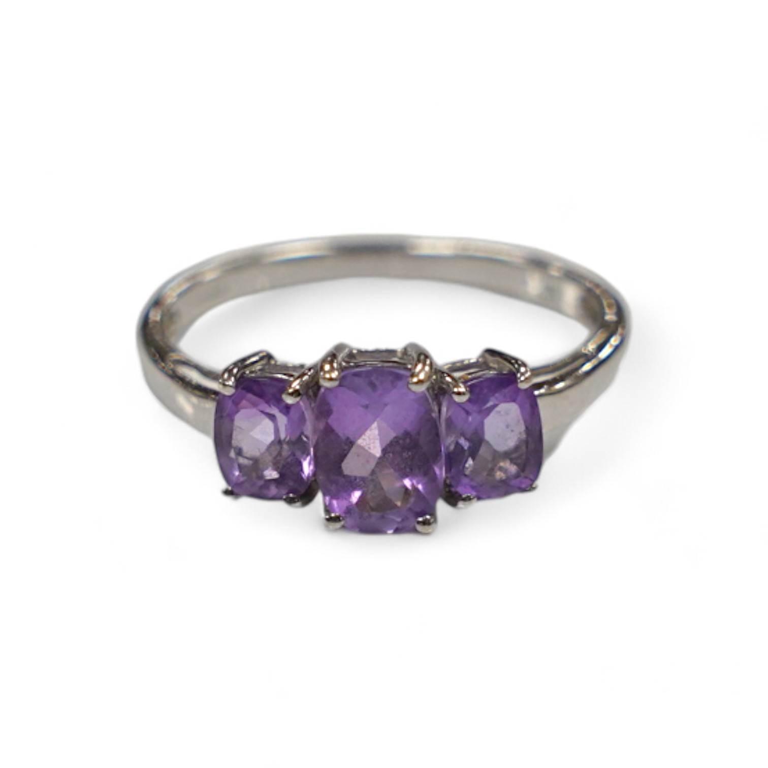 A modern 9ct gold and graduated three stone amethyst set dress ring, size O, gross weight 2.1 grams. Condition - fair to good